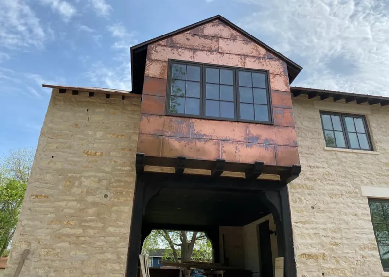 Copper metal panel facade on a stone building for Roof Repair in Malibu